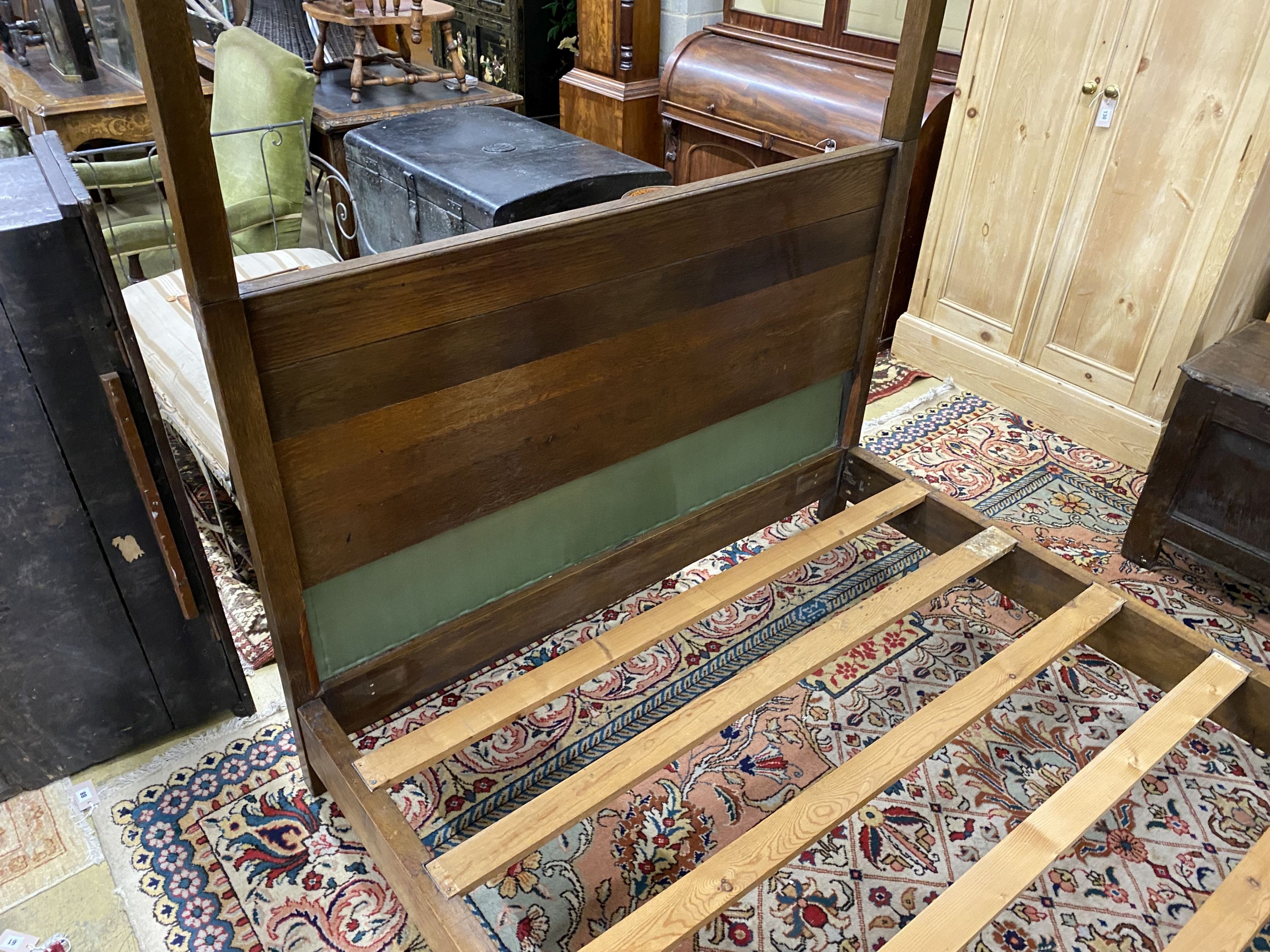 A George III style oak four poster bed frame, with drapes, length 205cm, width 152cm